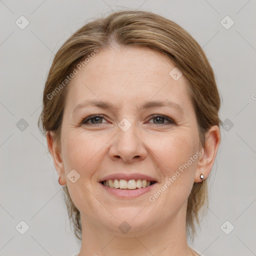 Joyful white adult female with medium  brown hair and grey eyes