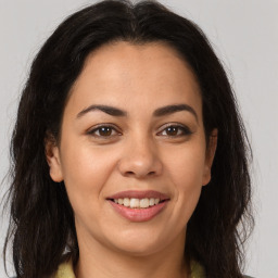 Joyful latino young-adult female with long  brown hair and brown eyes