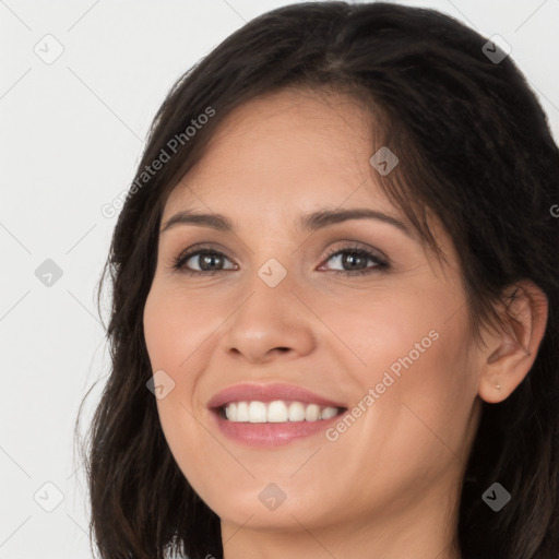 Joyful white young-adult female with long  brown hair and brown eyes