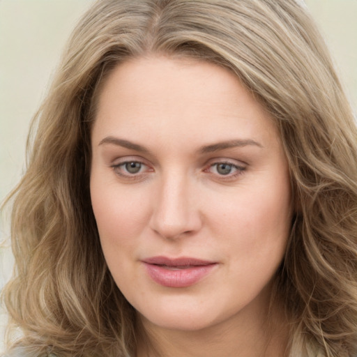 Joyful white young-adult female with long  brown hair and green eyes