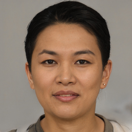 Joyful asian young-adult female with short  black hair and brown eyes