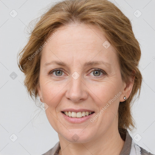 Joyful white adult female with medium  brown hair and grey eyes