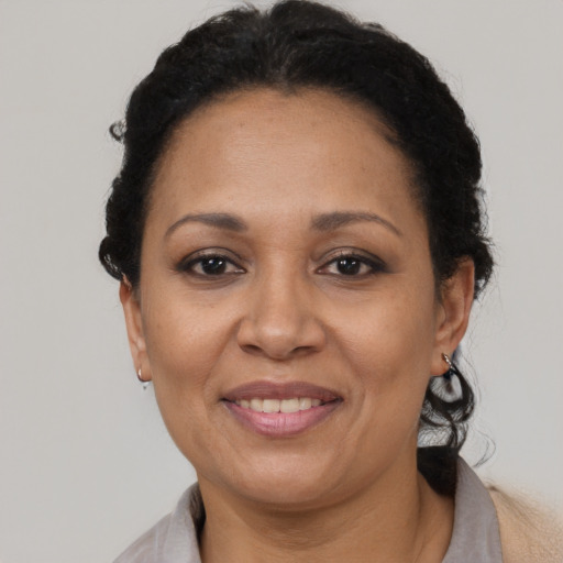 Joyful latino adult female with short  brown hair and brown eyes