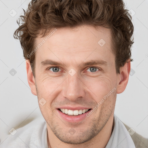 Joyful white adult male with short  brown hair and grey eyes