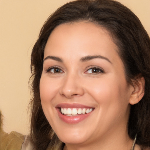 Joyful white young-adult female with long  brown hair and brown eyes