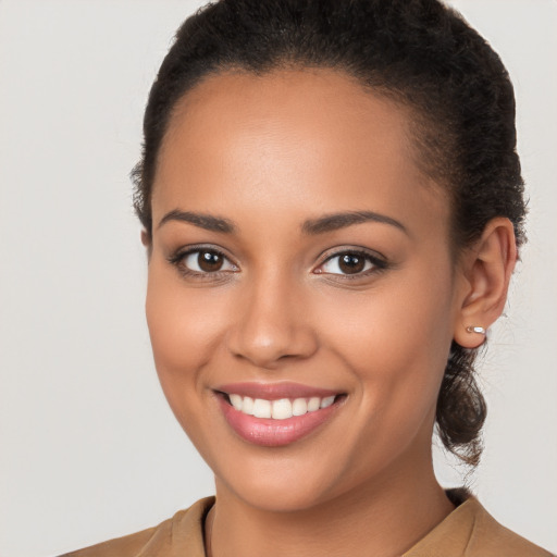 Joyful latino young-adult female with long  brown hair and brown eyes