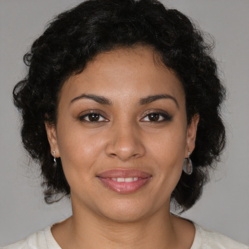 Joyful latino young-adult female with medium  brown hair and brown eyes