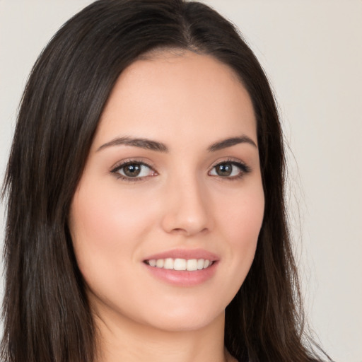 Joyful white young-adult female with long  brown hair and brown eyes