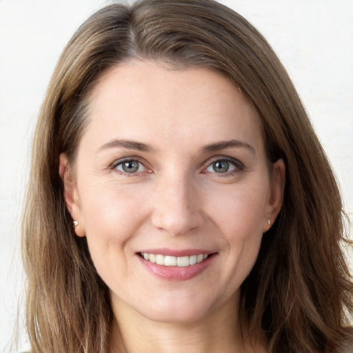 Joyful white young-adult female with long  brown hair and grey eyes