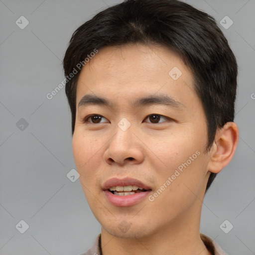 Joyful asian young-adult male with short  brown hair and brown eyes