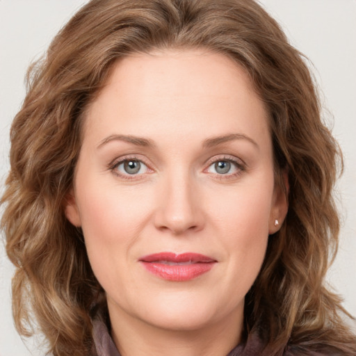 Joyful white young-adult female with long  brown hair and green eyes