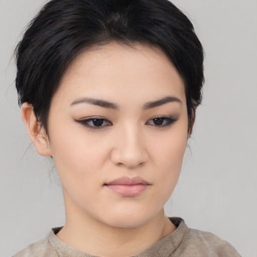 Joyful asian young-adult female with medium  black hair and brown eyes