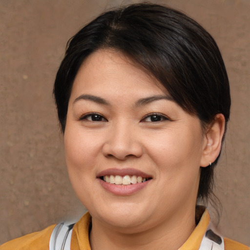 Joyful asian young-adult female with medium  brown hair and brown eyes