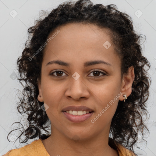 Joyful black young-adult female with long  brown hair and brown eyes