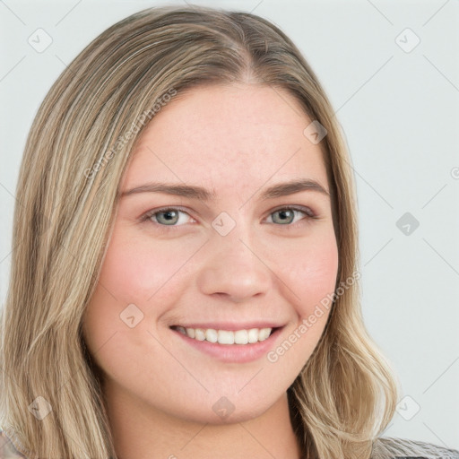 Joyful white young-adult female with long  brown hair and blue eyes