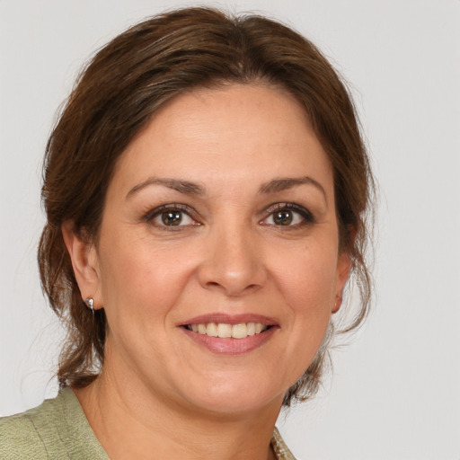 Joyful white adult female with medium  brown hair and brown eyes