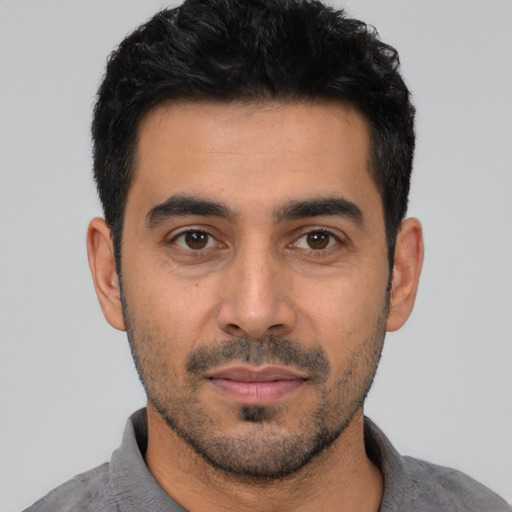 Neutral latino young-adult male with short  black hair and brown eyes