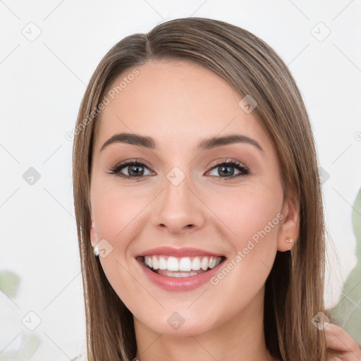 Joyful white young-adult female with long  brown hair and green eyes