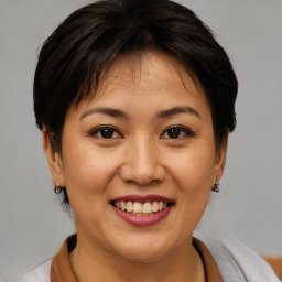 Joyful asian young-adult female with short  brown hair and brown eyes