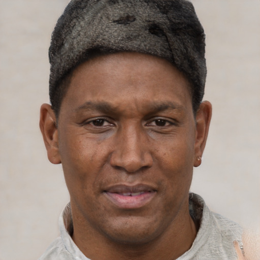 Joyful black adult male with short  brown hair and brown eyes