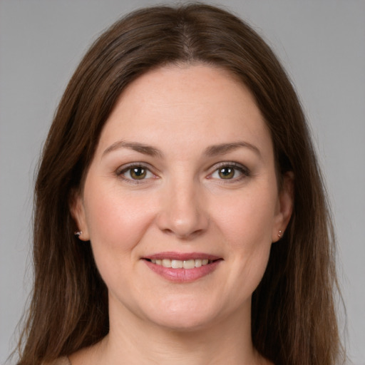 Joyful white young-adult female with long  brown hair and green eyes