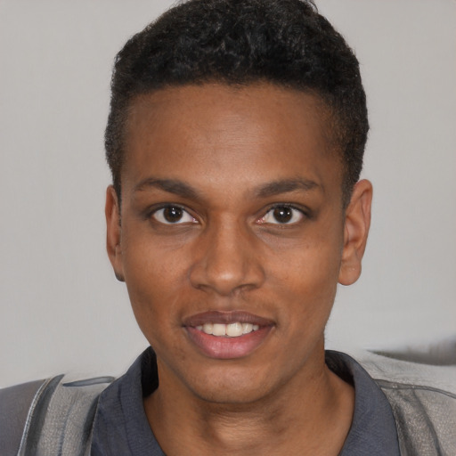 Joyful black young-adult male with short  black hair and brown eyes