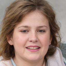 Joyful white young-adult female with medium  brown hair and blue eyes