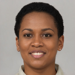 Joyful latino young-adult female with short  black hair and brown eyes