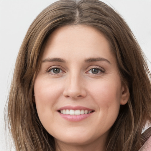 Joyful white young-adult female with long  brown hair and grey eyes