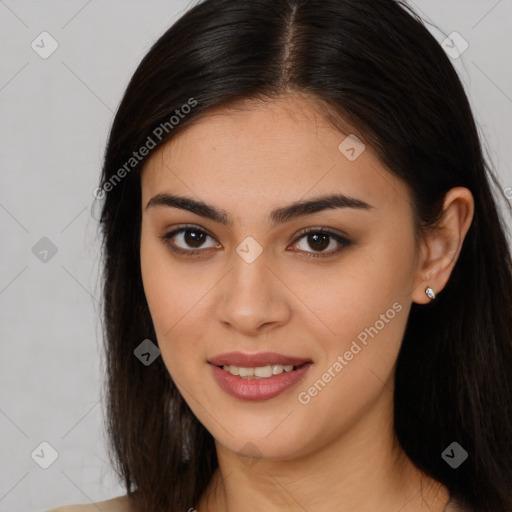 Joyful latino young-adult female with long  brown hair and brown eyes