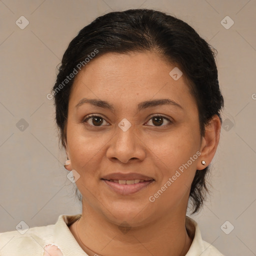 Joyful latino adult female with medium  brown hair and brown eyes