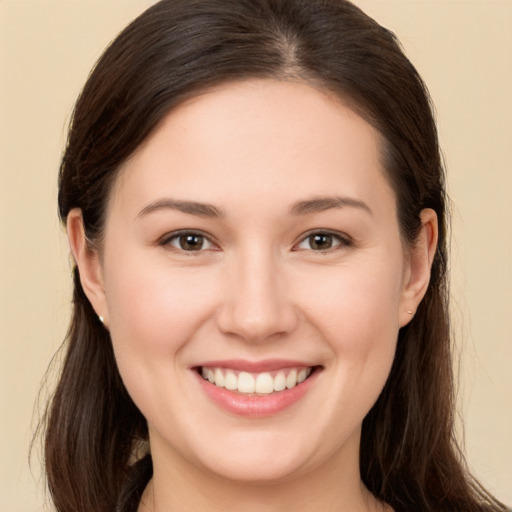 Joyful white young-adult female with long  brown hair and brown eyes