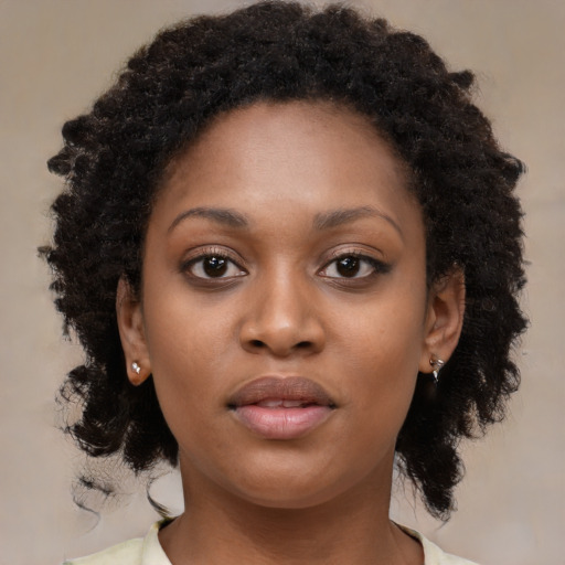 Neutral black young-adult female with medium  brown hair and brown eyes