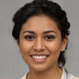 Joyful latino young-adult female with short  brown hair and brown eyes