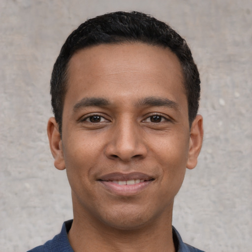 Joyful latino young-adult male with short  black hair and brown eyes