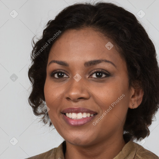 Joyful black young-adult female with long  brown hair and brown eyes