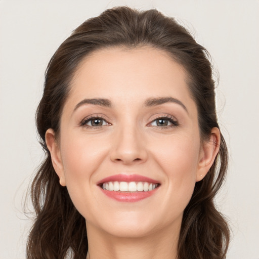 Joyful white young-adult female with long  brown hair and brown eyes