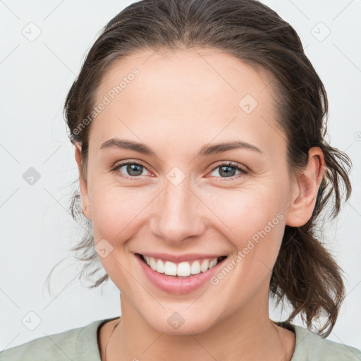 Joyful white young-adult female with medium  brown hair and grey eyes