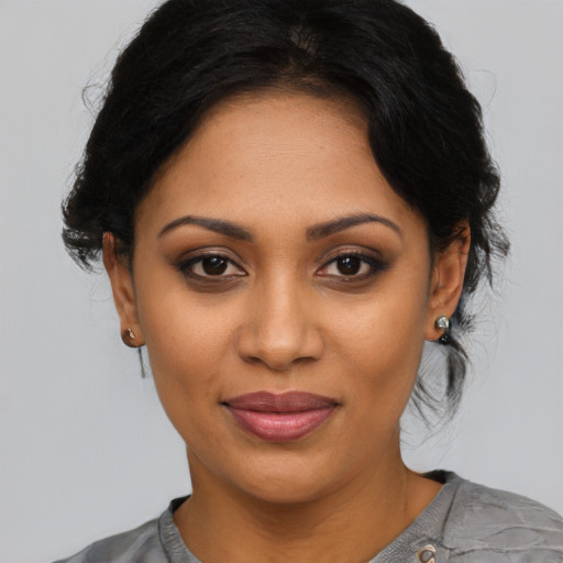 Joyful latino young-adult female with medium  black hair and brown eyes