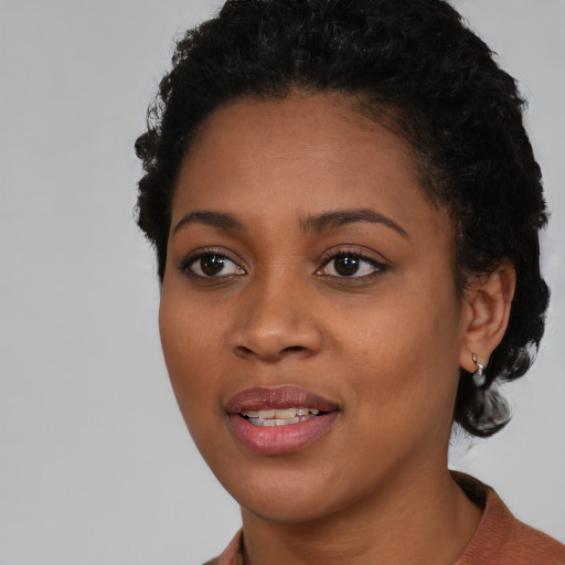 Joyful latino young-adult female with short  black hair and brown eyes
