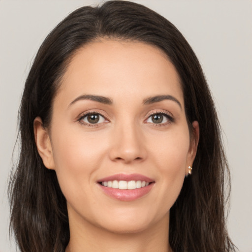 Joyful white young-adult female with long  brown hair and brown eyes