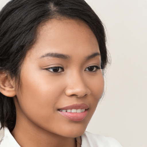 Joyful latino young-adult female with medium  brown hair and brown eyes