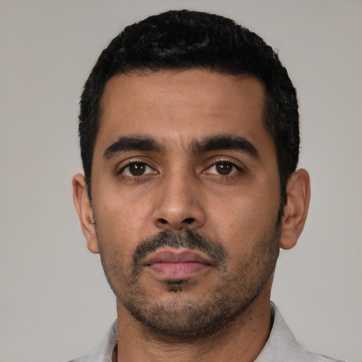 Neutral latino young-adult male with short  black hair and brown eyes