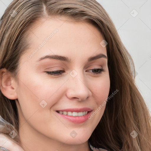 Joyful white young-adult female with long  brown hair and blue eyes