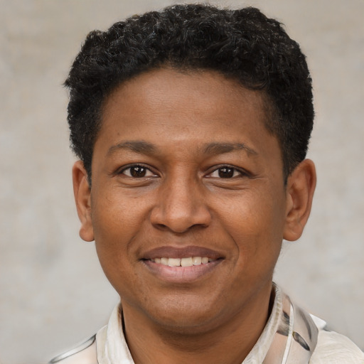 Joyful latino adult male with short  brown hair and brown eyes