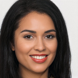 Joyful latino young-adult female with long  brown hair and brown eyes