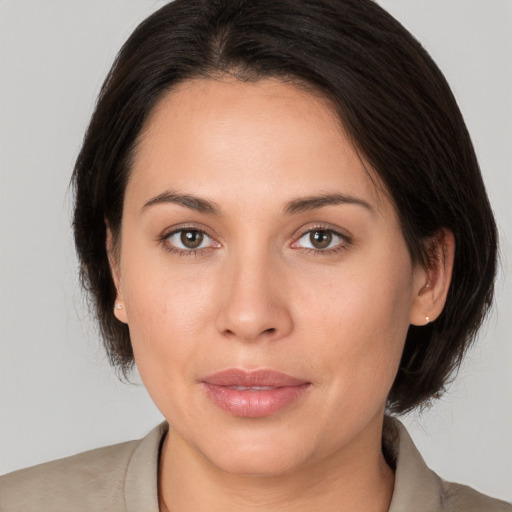 Joyful white young-adult female with medium  brown hair and brown eyes