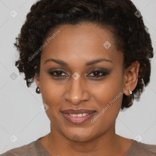 Joyful black adult female with short  brown hair and brown eyes