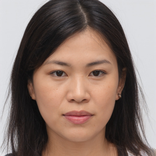 Joyful asian young-adult female with long  brown hair and brown eyes