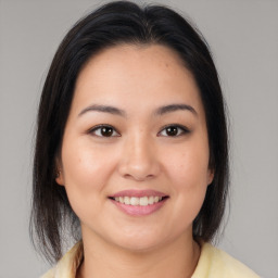 Joyful latino young-adult female with medium  brown hair and brown eyes